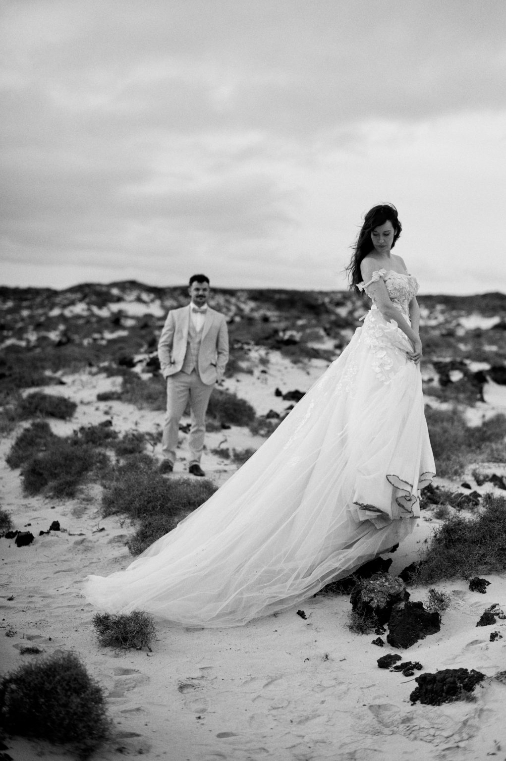 Couple on the volcanic coast, black and white, Lanzarote