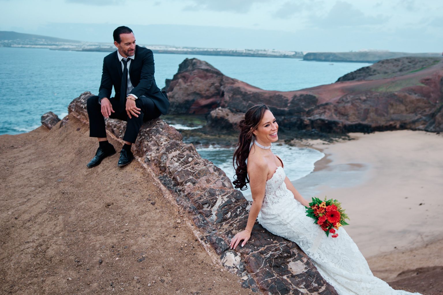 Juan and Laura by a turquoise cove, Lanzarote