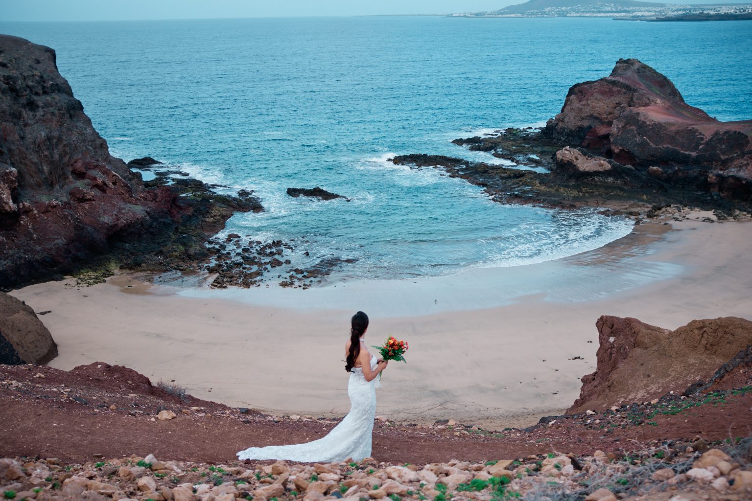 Turquoise water and red rock on the Lanzarote coast