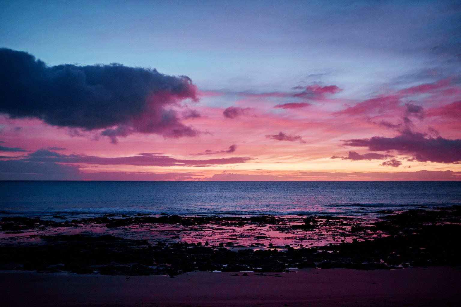 Pink dawn over the black rock coast of Lanzarote