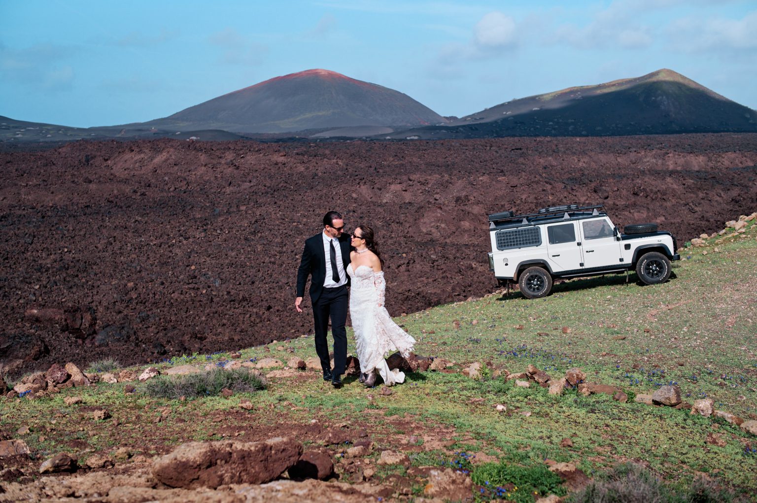 Couple with their Land Rover on a green ridge, Lanzarote