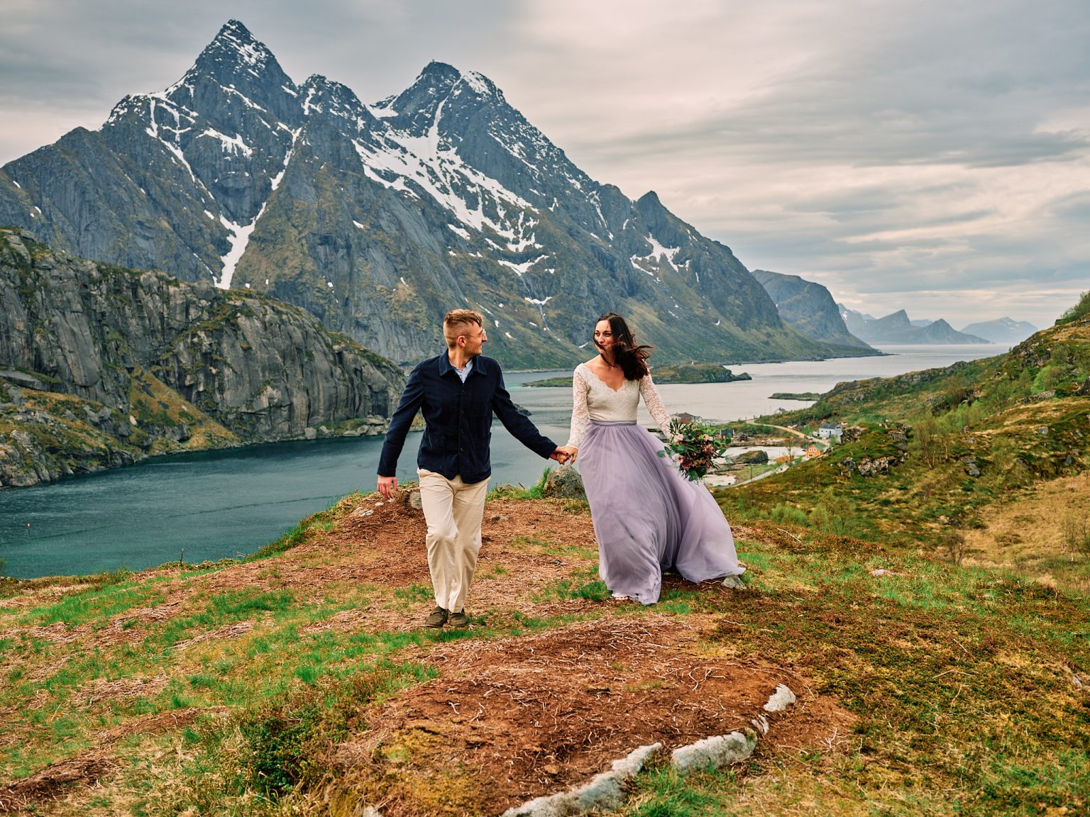 Sophie and Johan walking a ridge over the Lofoten fjords