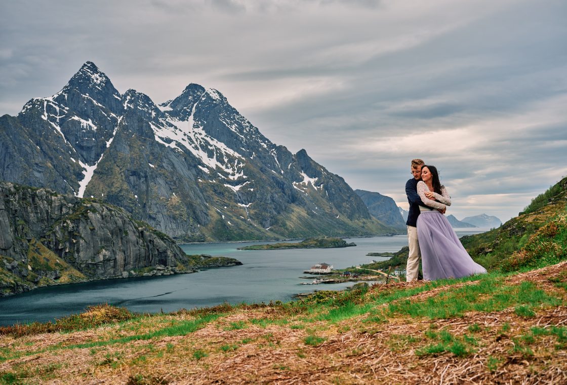 Sophie and Johan embracing below a Lofoten peak