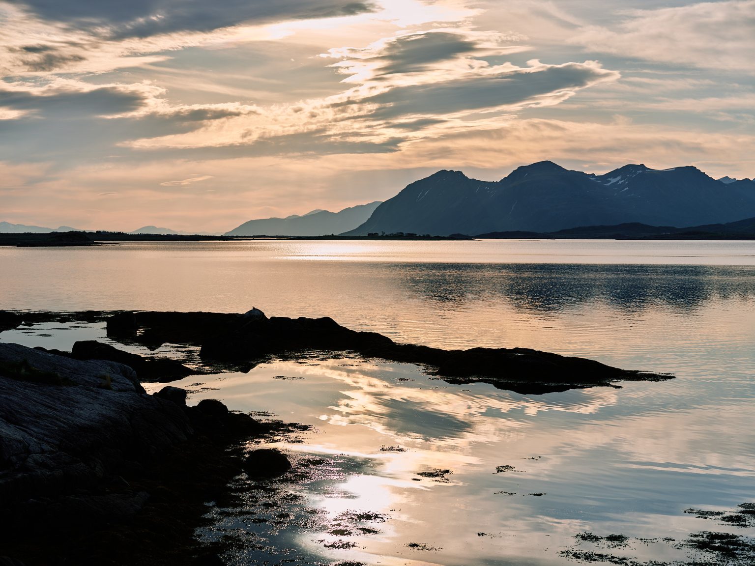 Sunset over the fjord and mountains in Lofoten