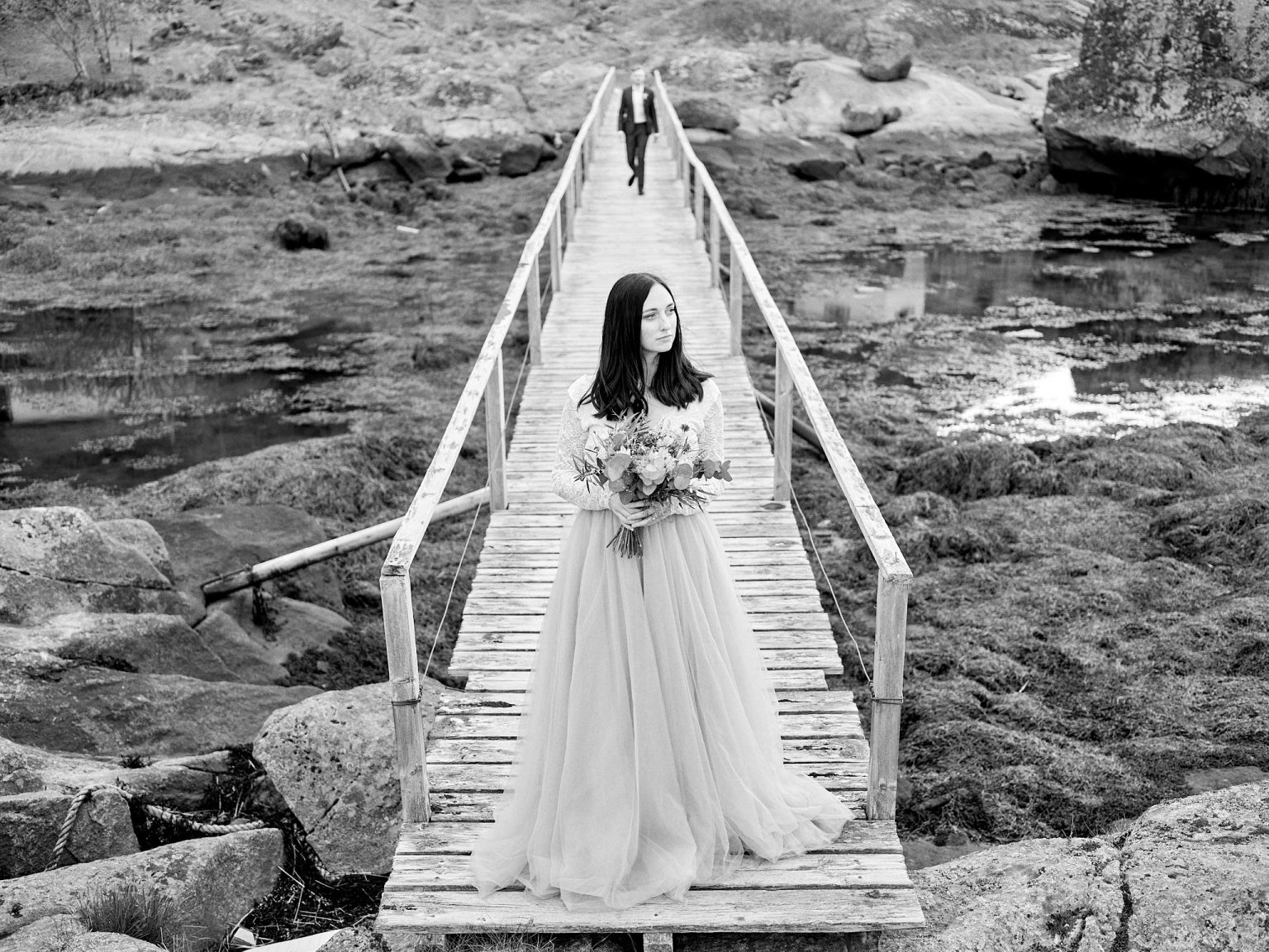 The bride on a wooden pier in Lofoten, black and white