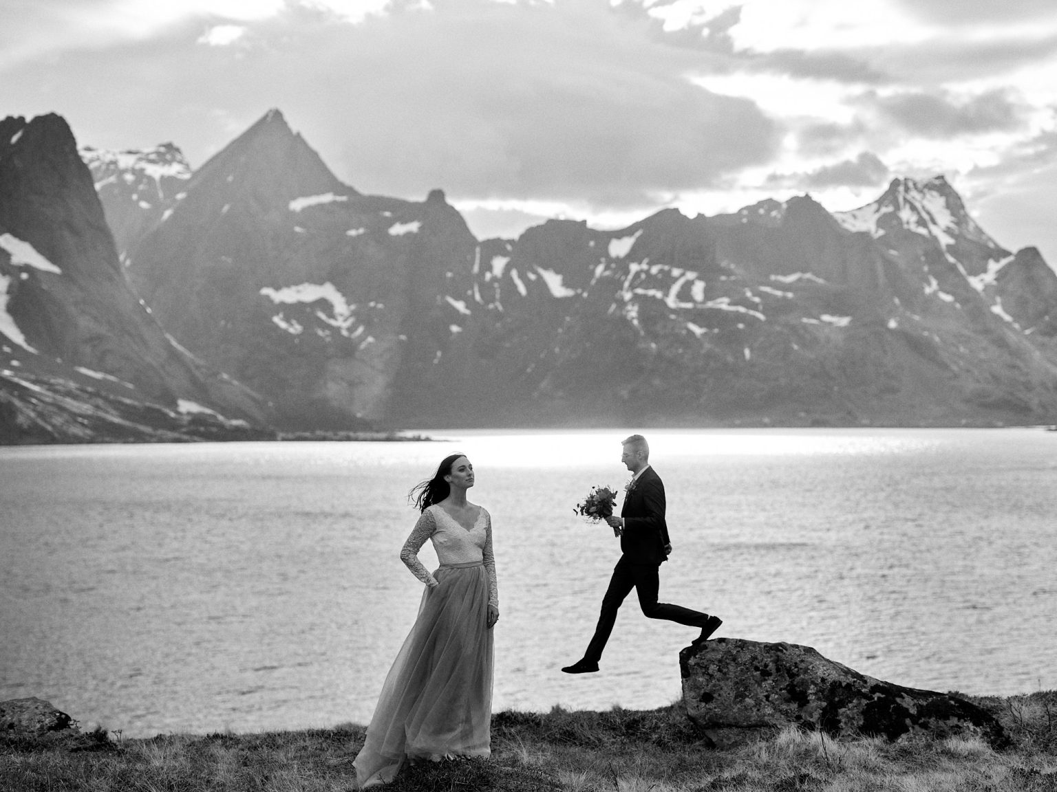 Sophie and Johan on the shore below the Lofoten mountains, black and white