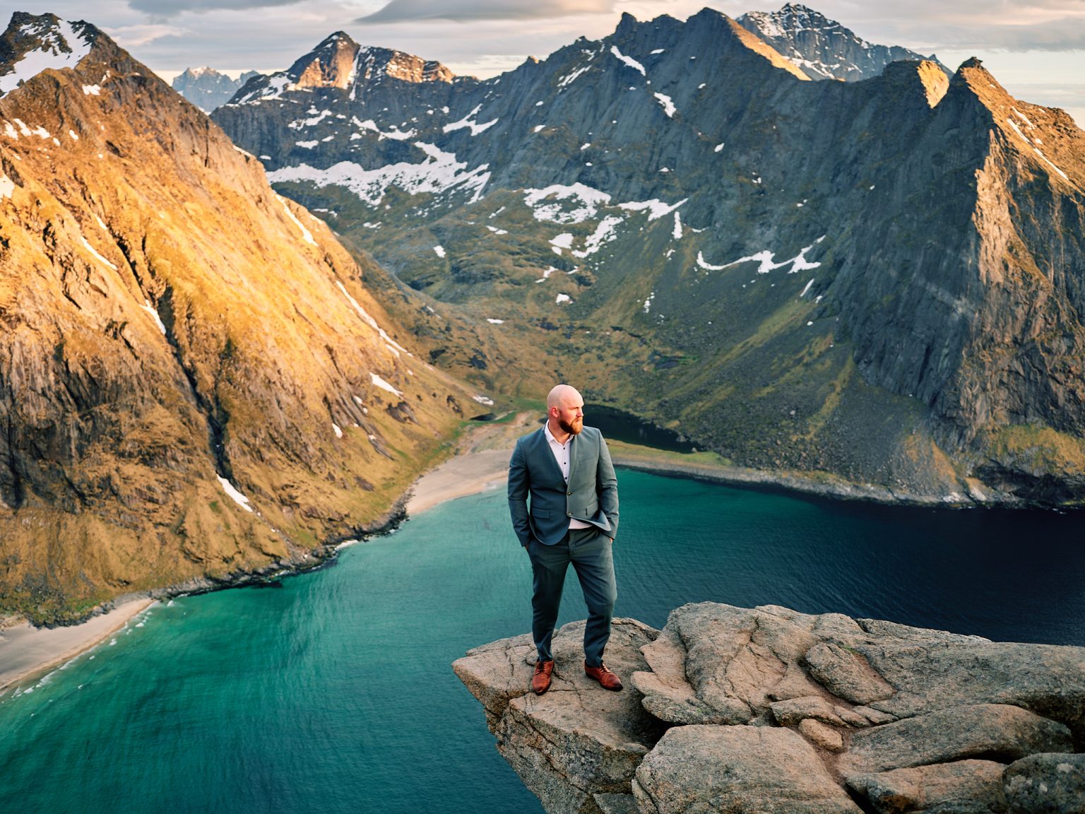 The groom overlooking Kvalvika beach from Ryten