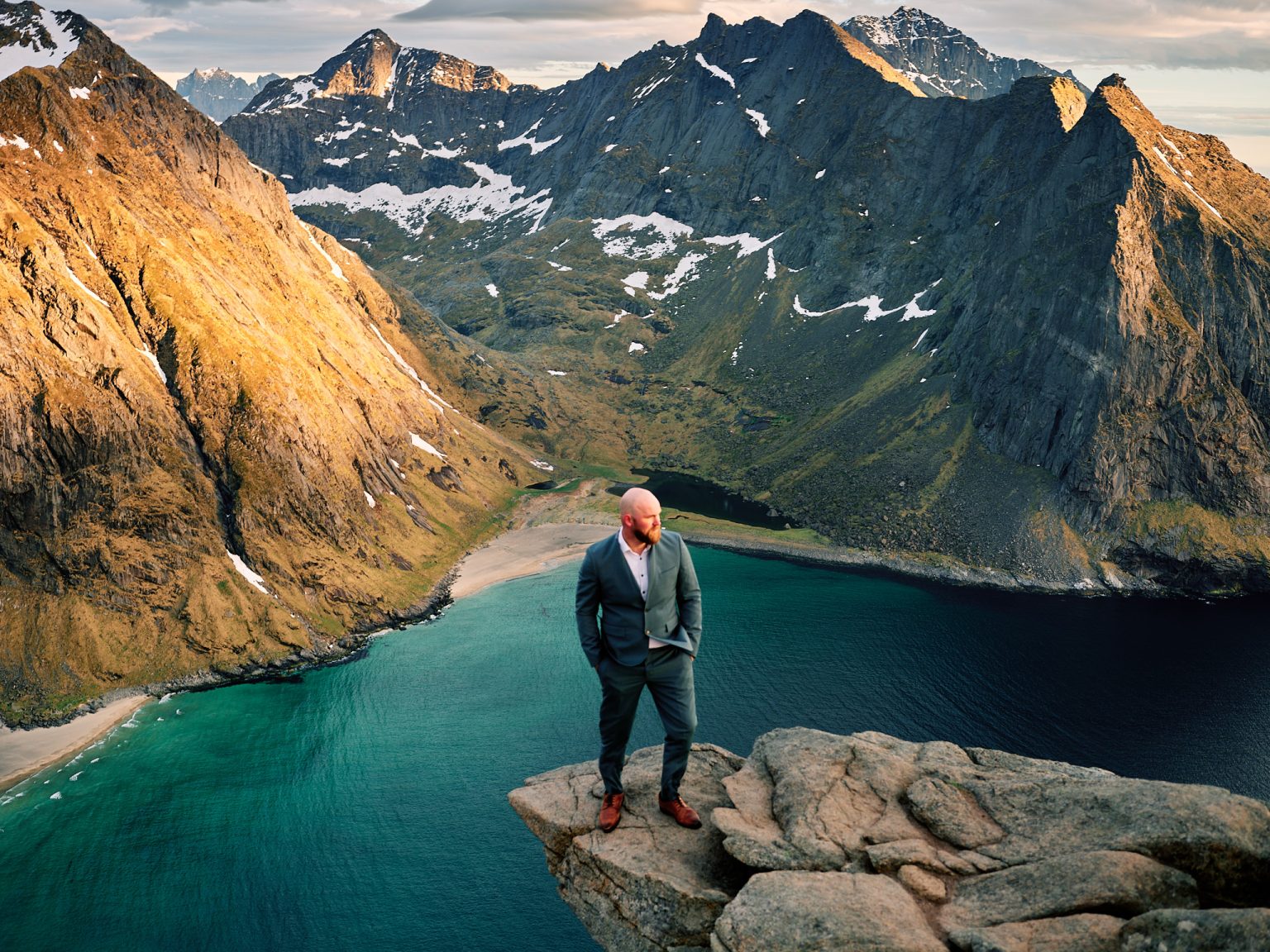 Groom on a rock above the turquoise water, Ryten, Lofoten