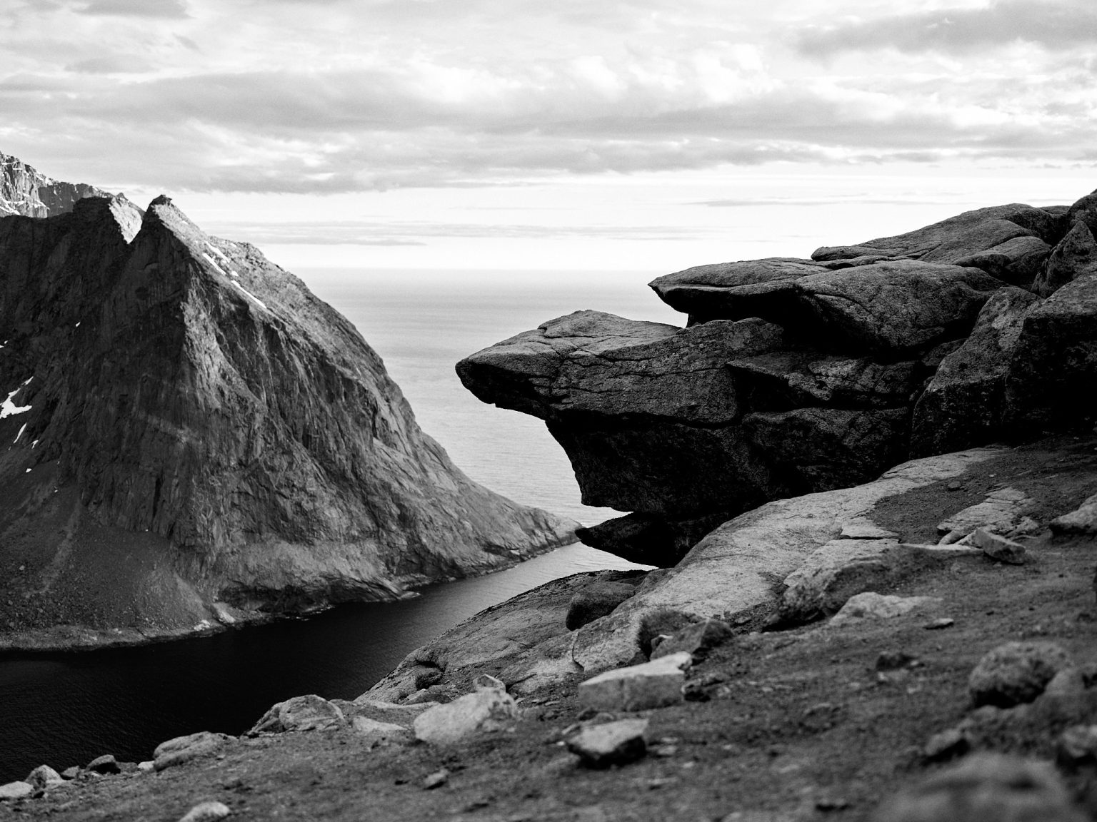 The rocky summit of Ryten over the sea, black and white