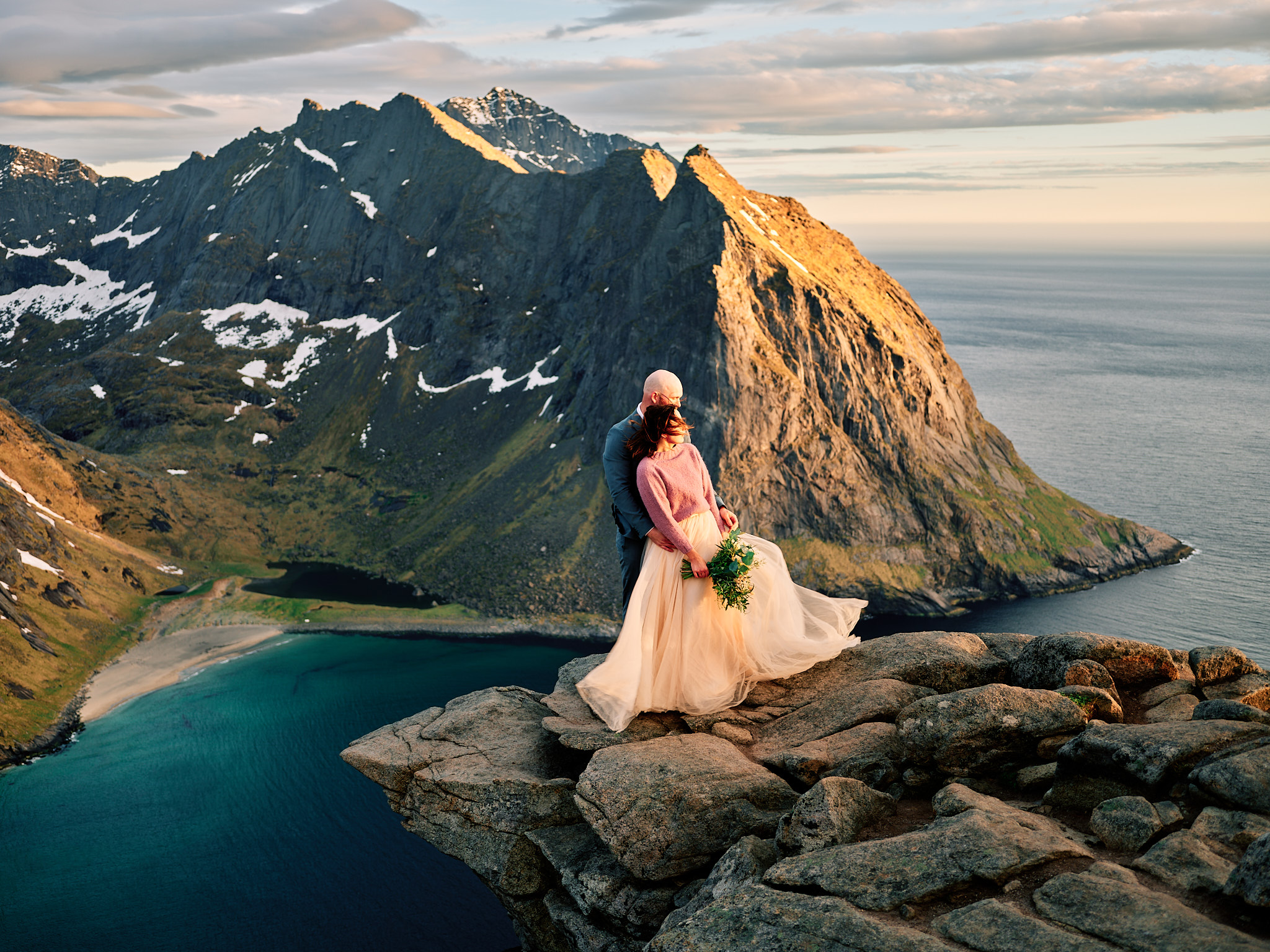 Ine and Jimmy embracing on Ryten at golden hour, Lofoten