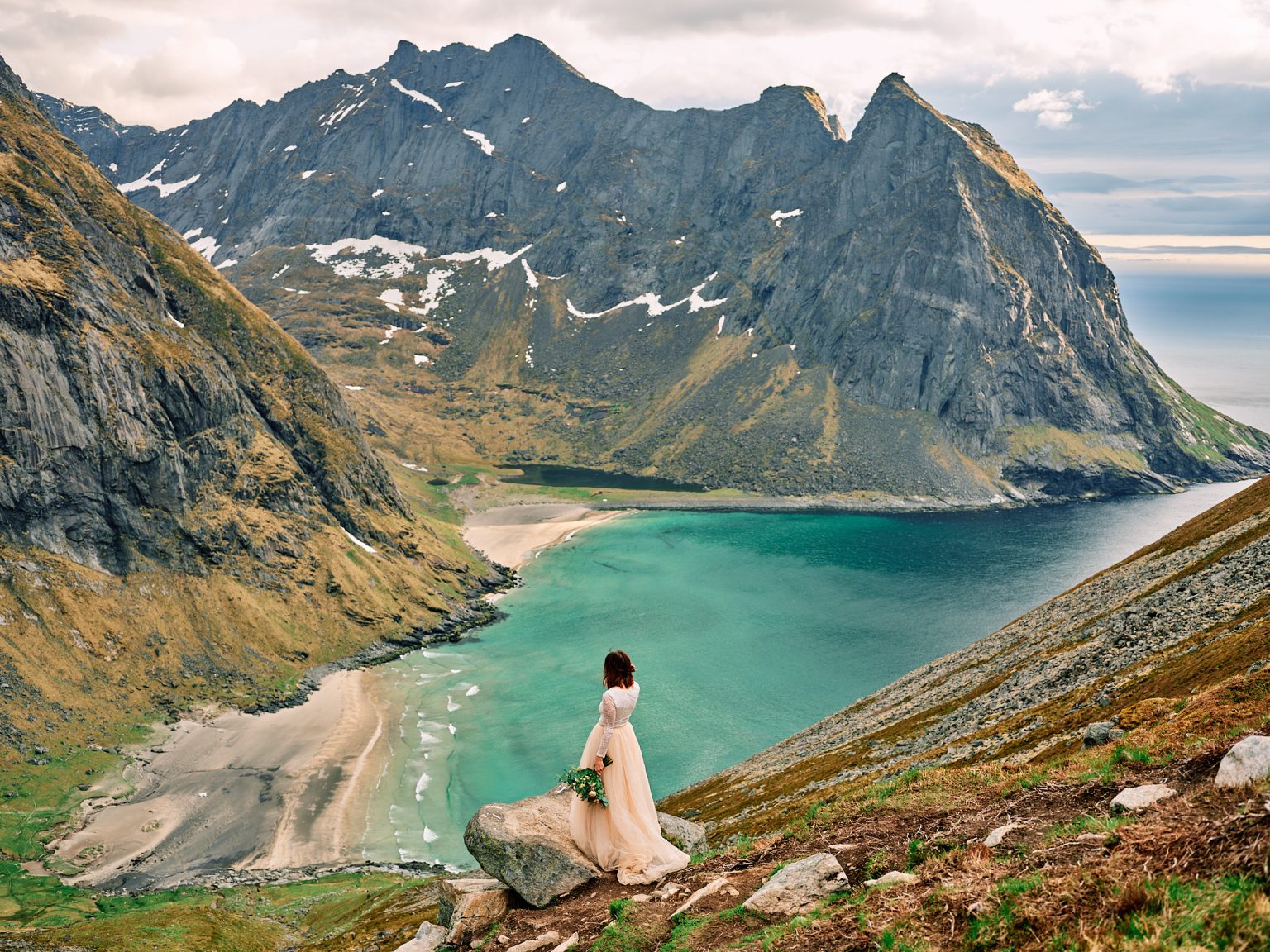 Bride on the summit of Ryten above Kvalvika beach, Lofoten