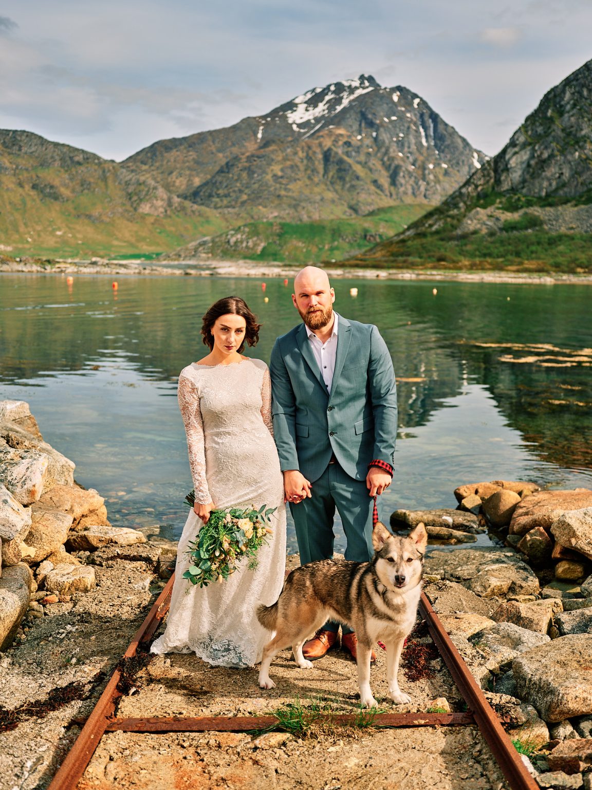 Ine and Jimmy with their dog by the water, Lofoten