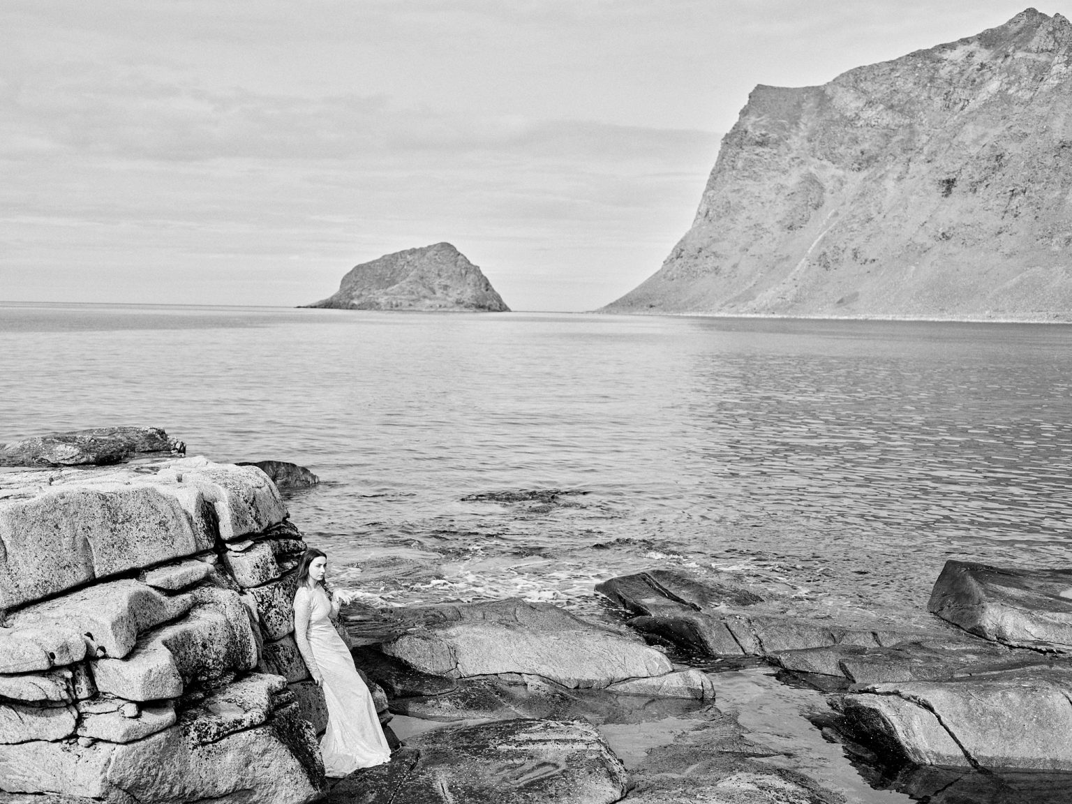 The couple small on the Lofoten coast, black and white