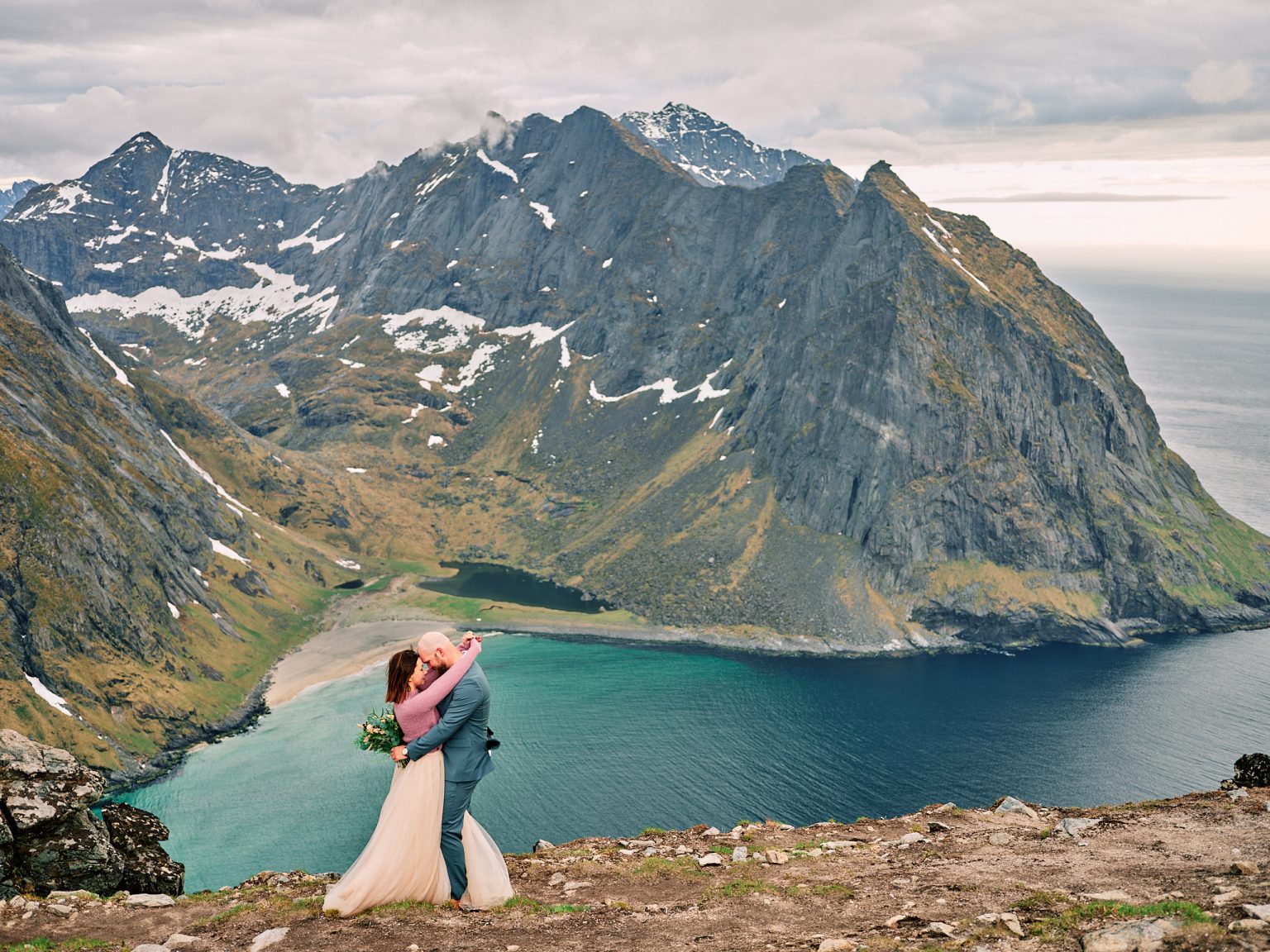 Ine and Jimmy embracing on the summit of Ryten, Lofoten