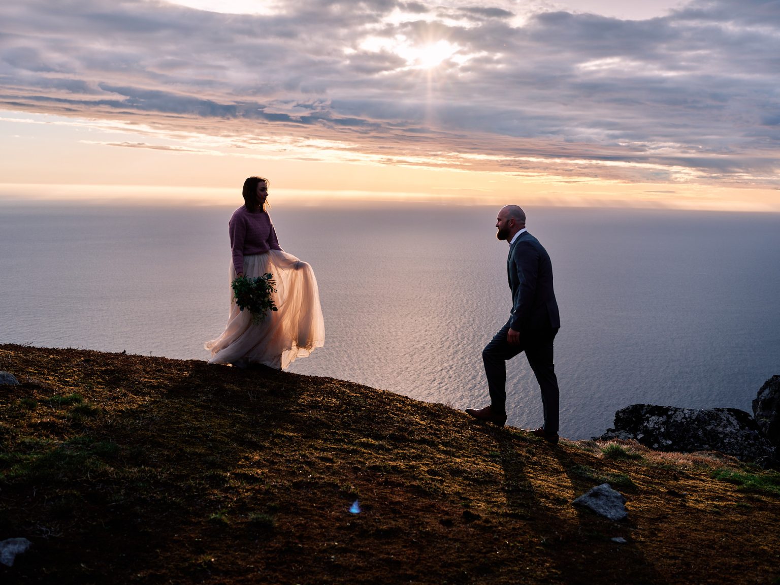 The couple at sunset on the summit, Lofoten