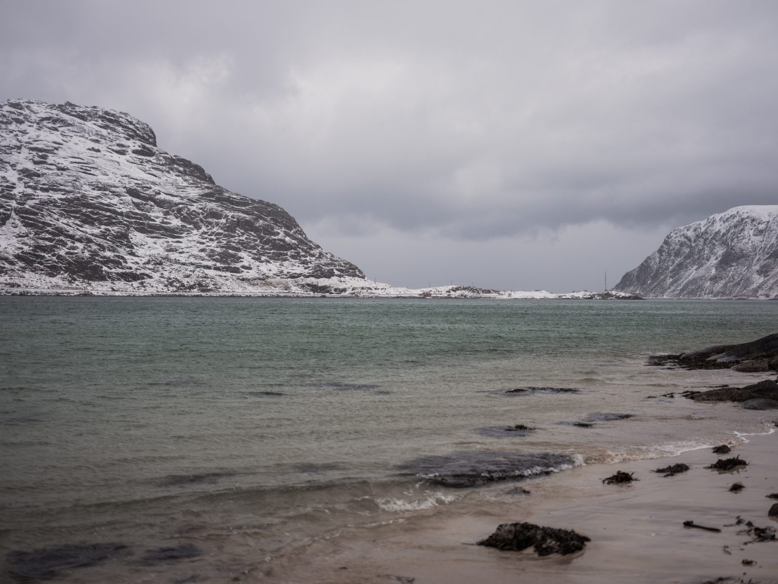 A turquoise Lofoten beach under snow, Norway