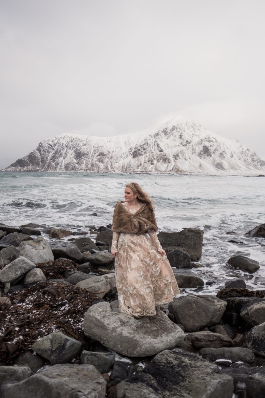 The couple embracing on the rocks, Lofoten in winter