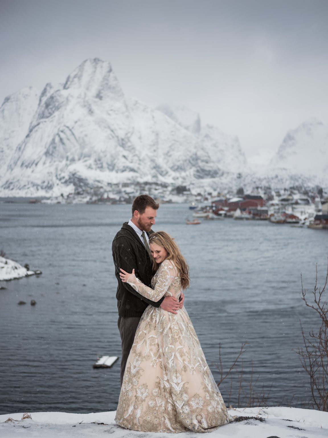 Embracing below the peak at Reine, a Lofoten winter elopement