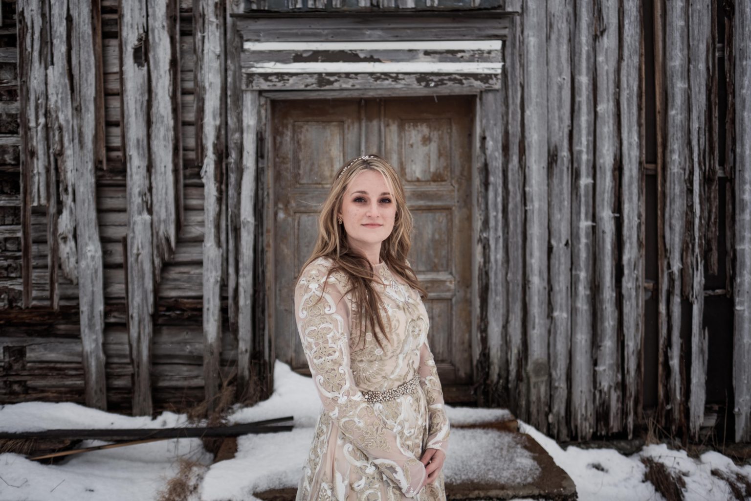Jamie in a doorway of old silvered timber, Lofoten