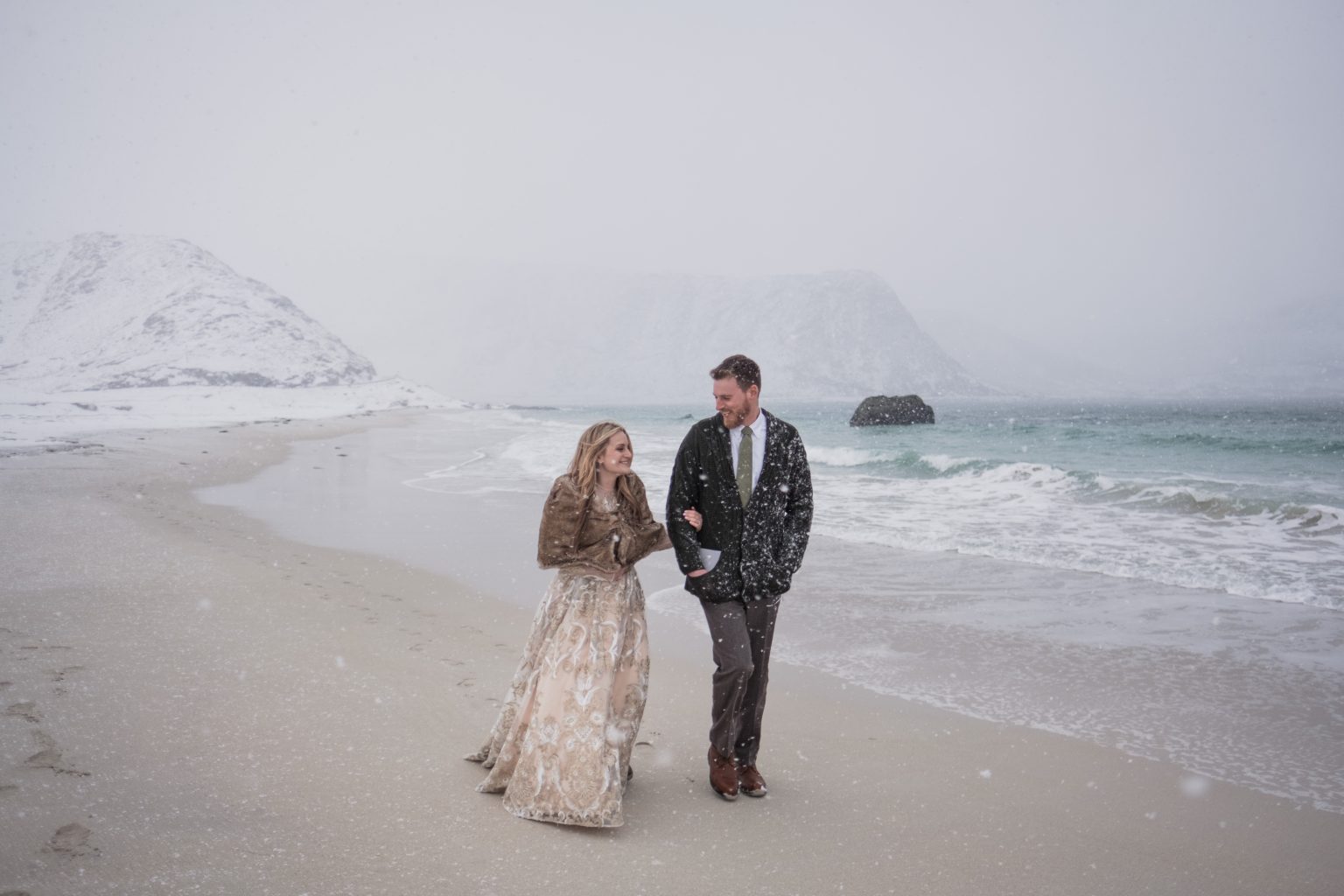 Jamie and Christopher on a snowy beach, Lofoten, Norway