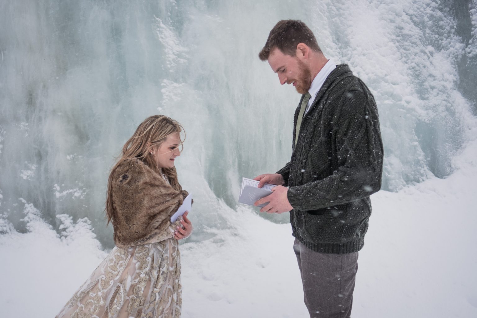 Reading vows at the blue ice wall, a Lofoten winter elopement