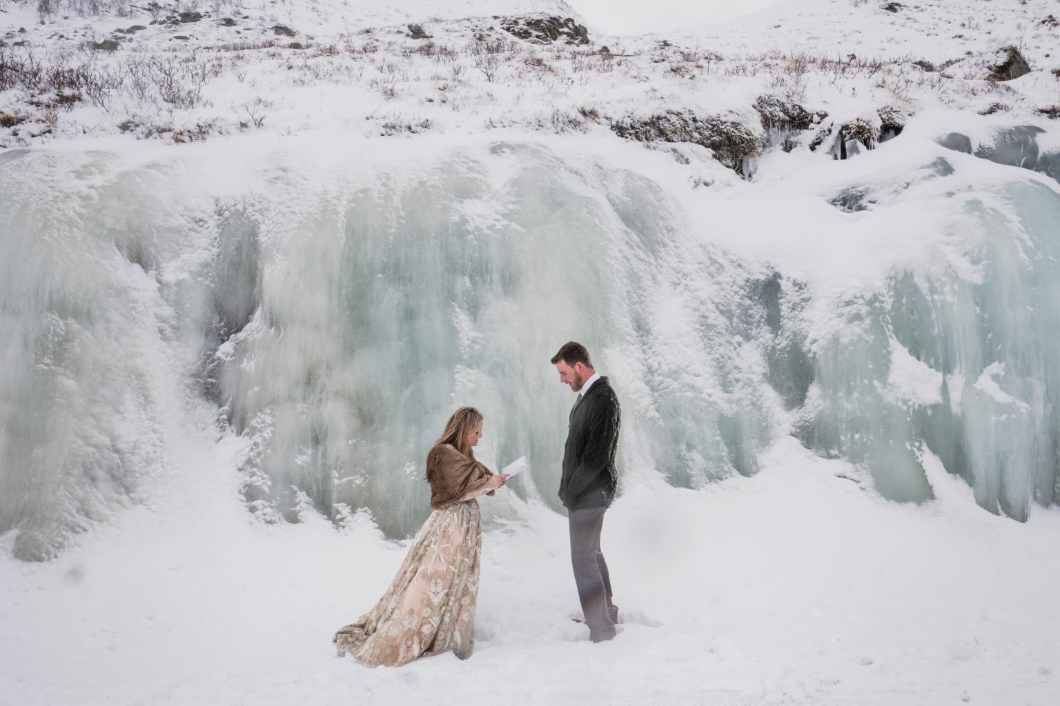 Jamie and Christopher embracing at the ice wall, Lofoten