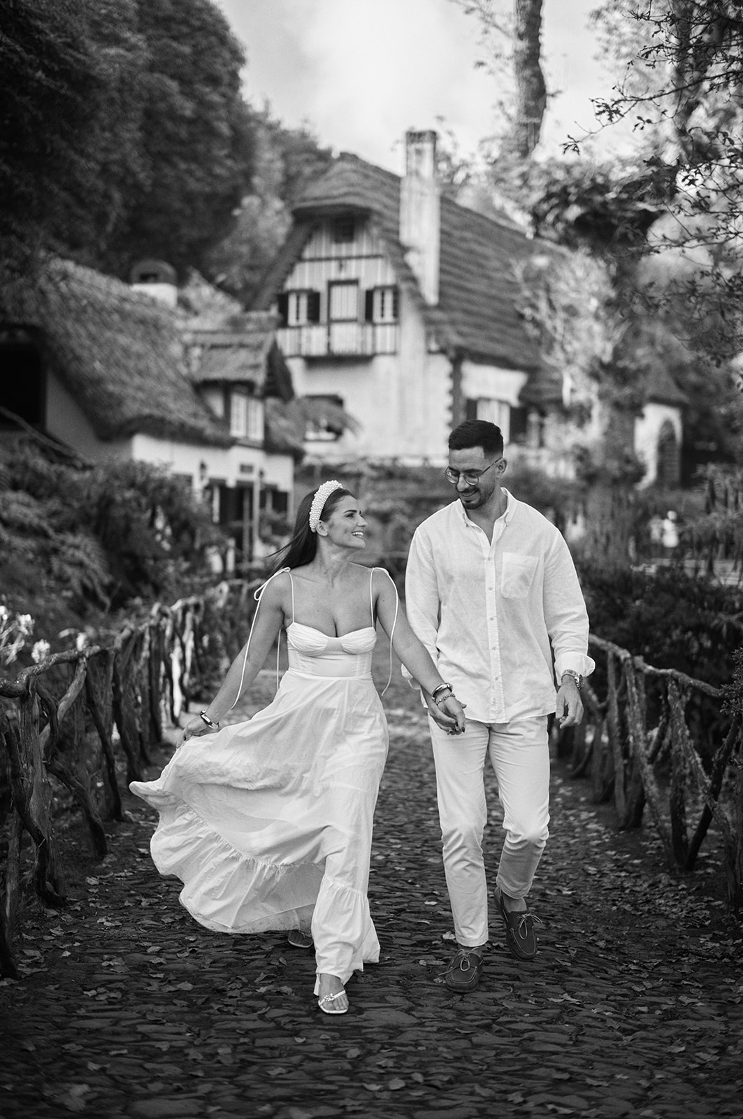 Couple with the Madeira hills behind them in black and white