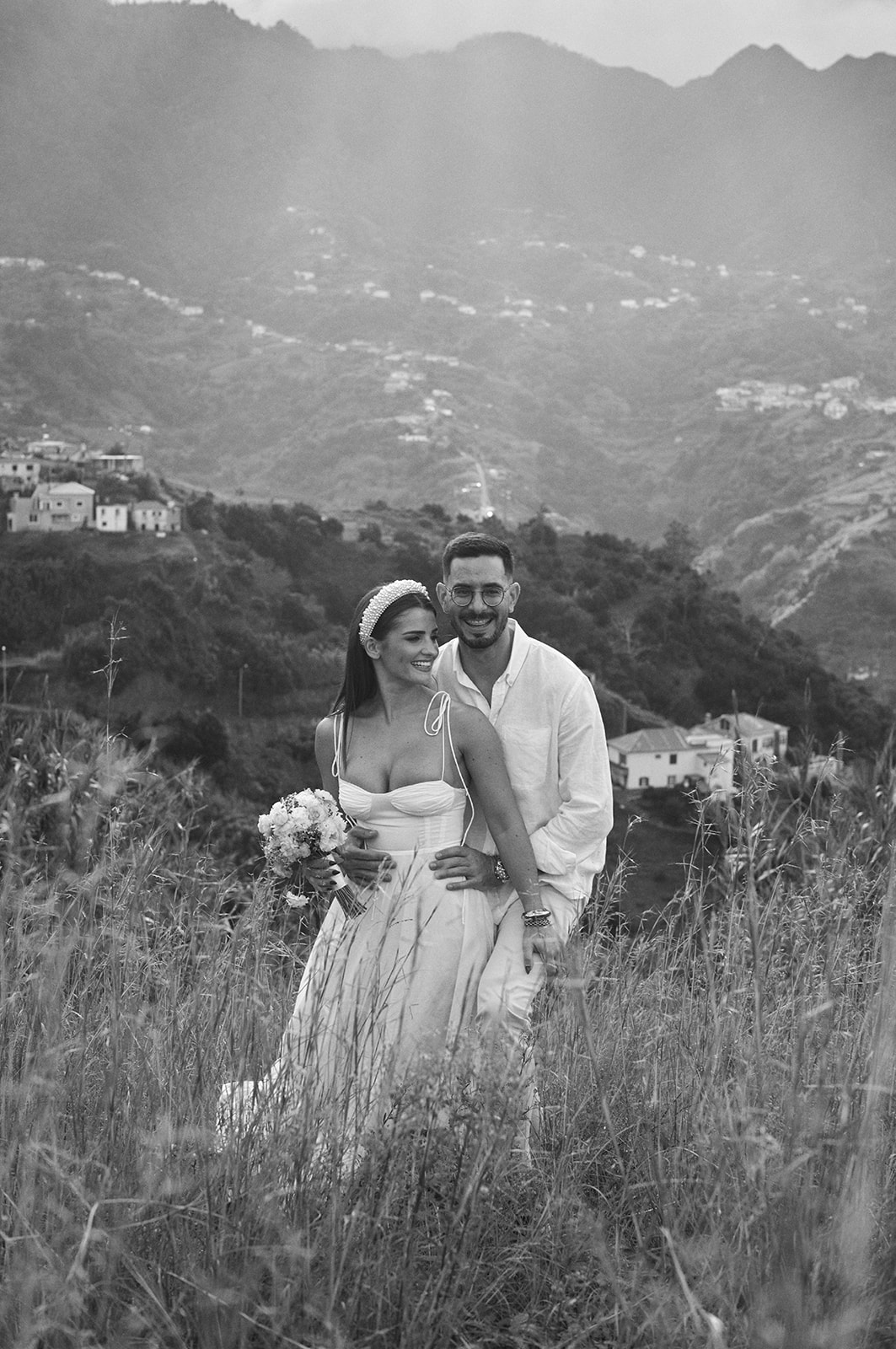 Bride and groom at a clifftop picnic on the Madeira north coast in black and white