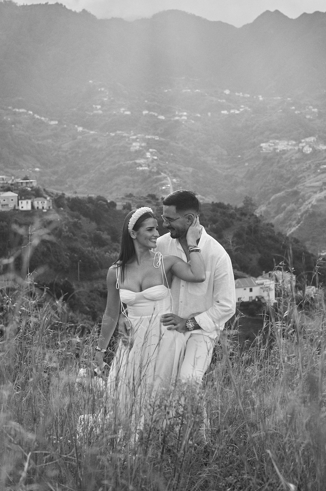 Couple close together above the Madeira coast in black and white
