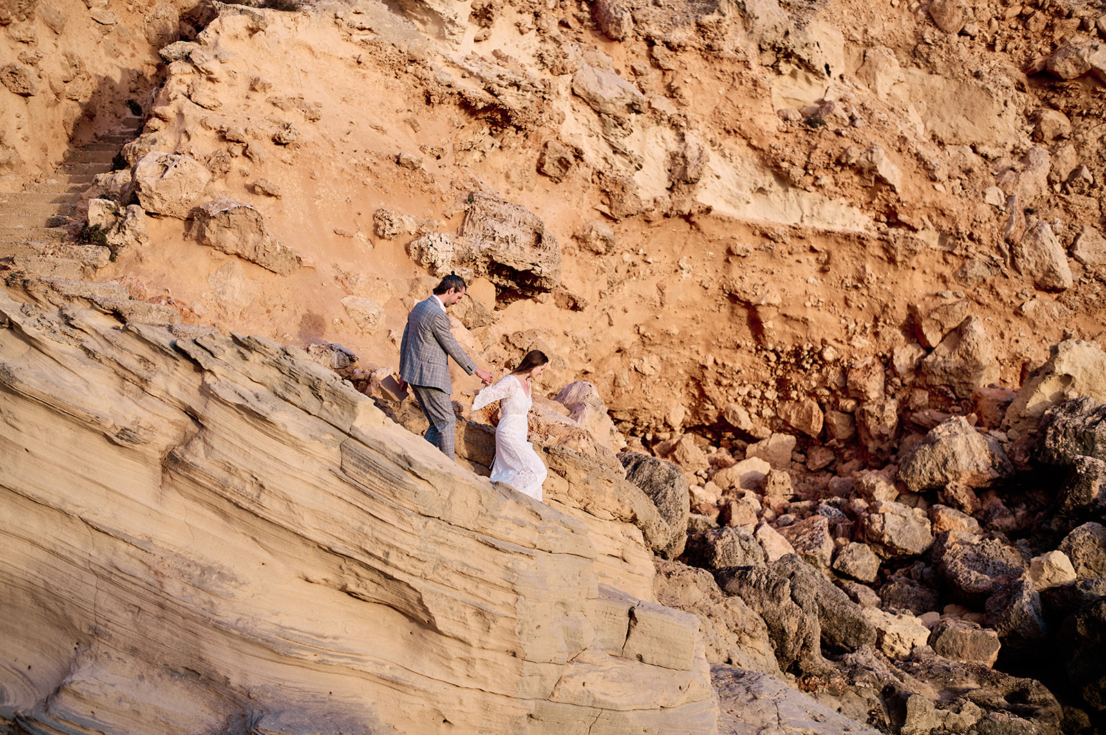 Couple on the cliffs at Cala del Toro at sunset