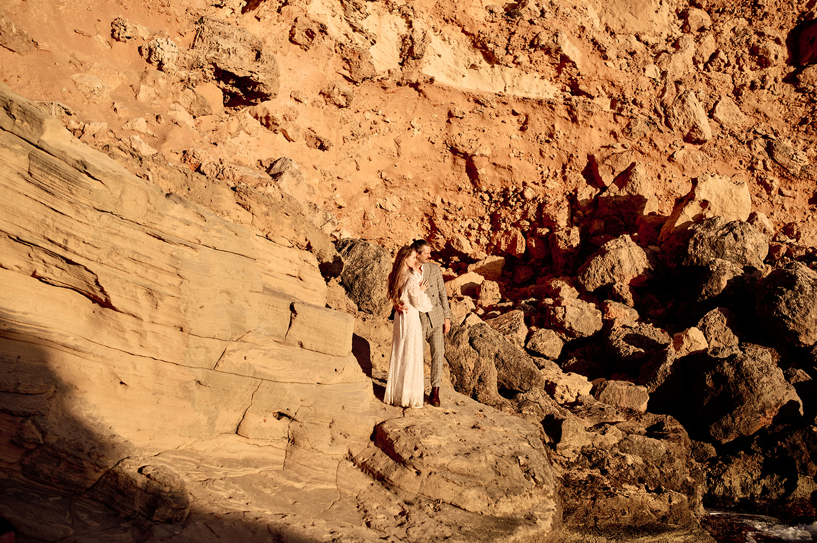 Couple on the cliffs at Cala del Toro at sunset