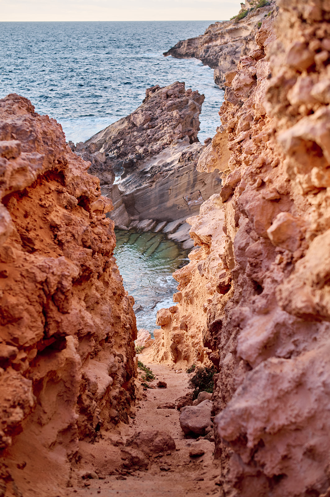 Couple on the cliffs at Cala del Toro at sunset