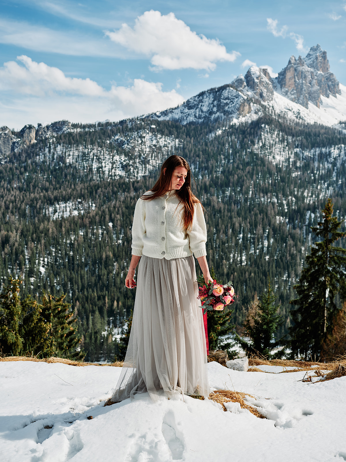 Bride with her bouquet in the winter Dolomites at Passo Gardena, Val Gardena - Nordica Photography