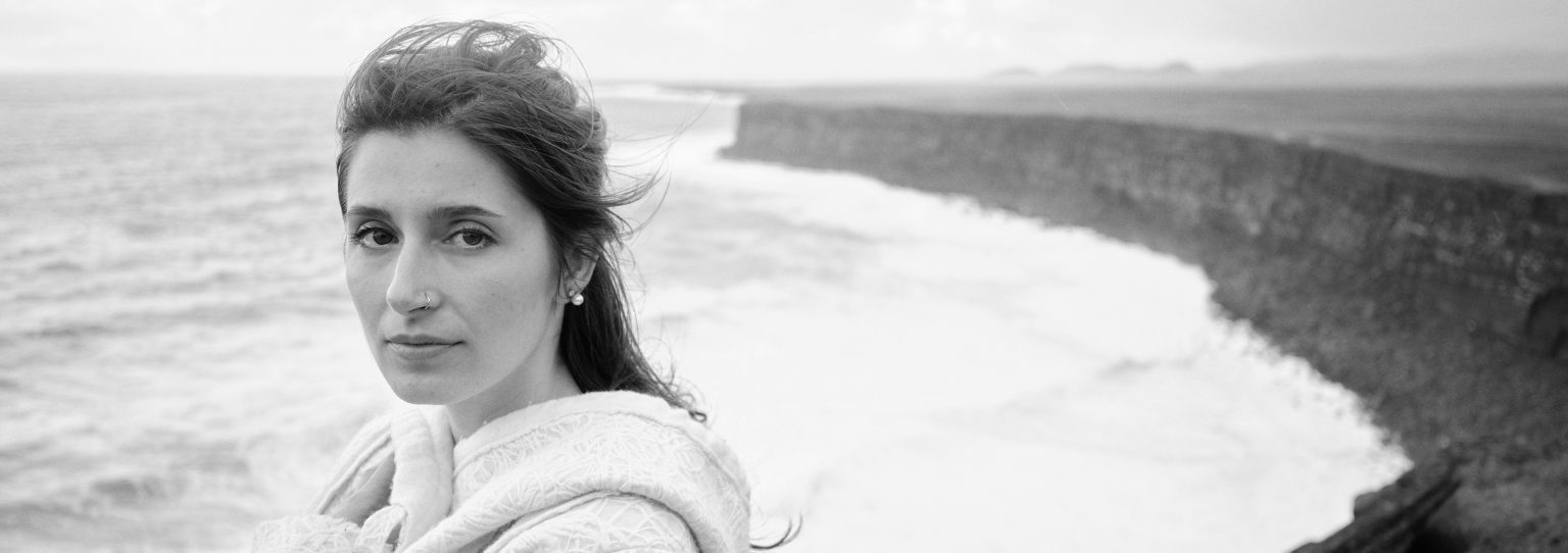 Black and white portrait of Andreea on the Reykjanes cliffs