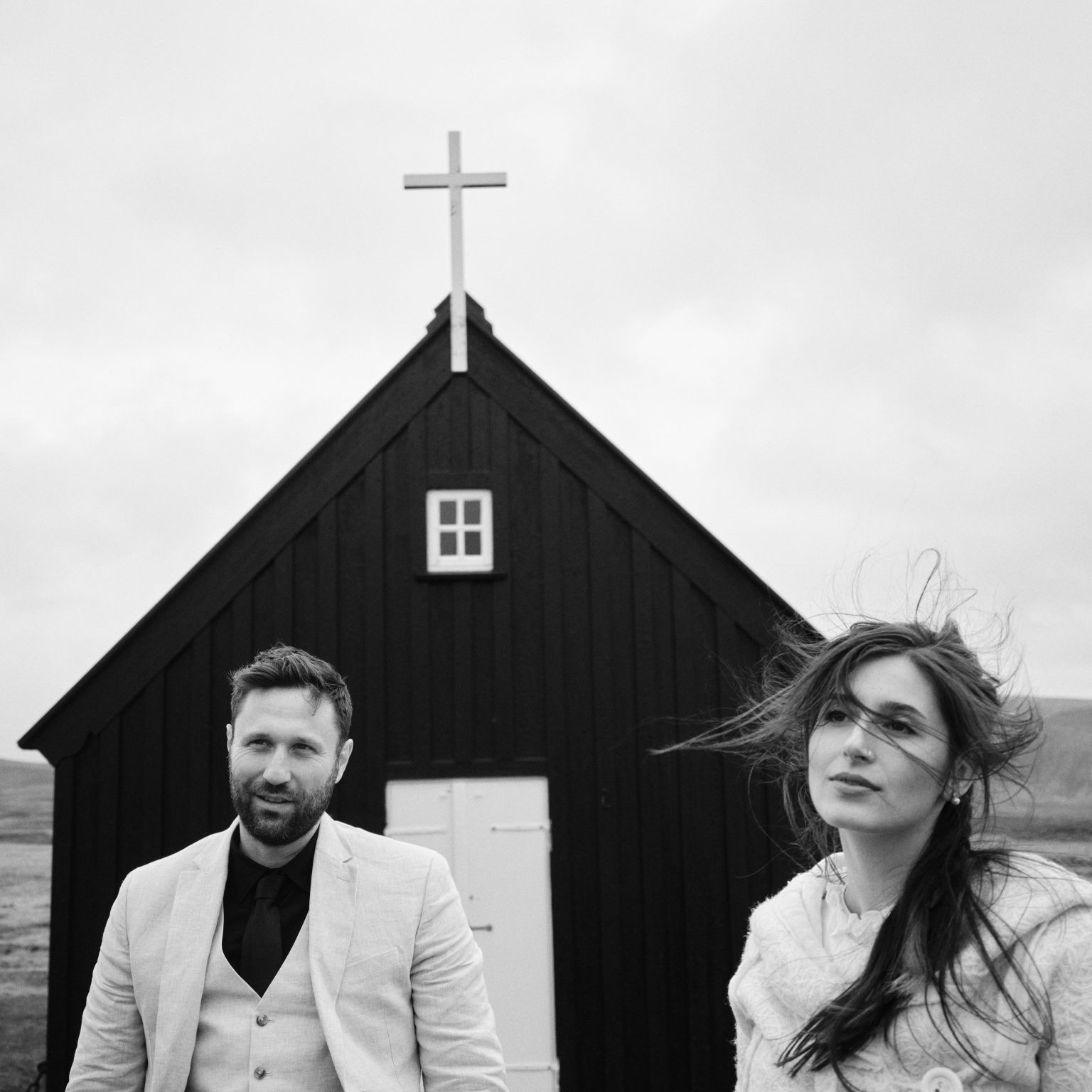 The couple in front of the black church at Krýsuvík, Reykjanes