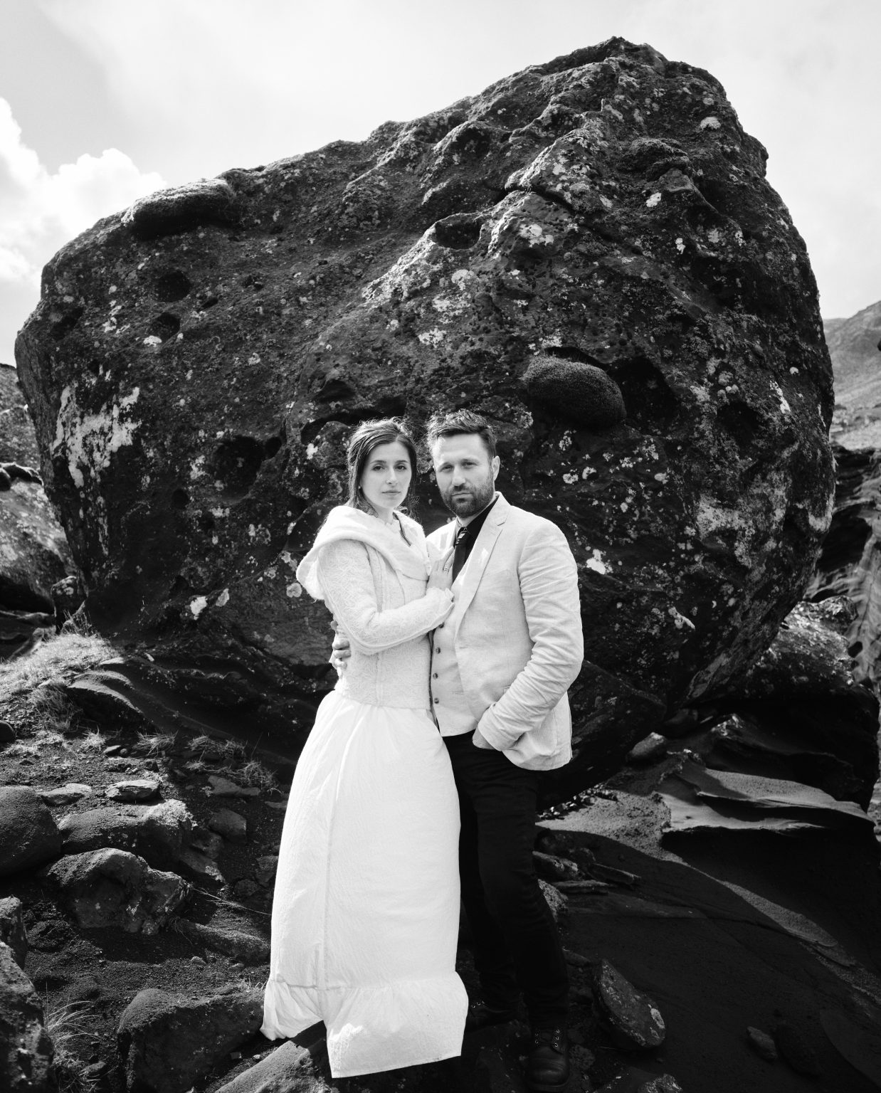 Couple beside a huge lava boulder, Krýsuvík
