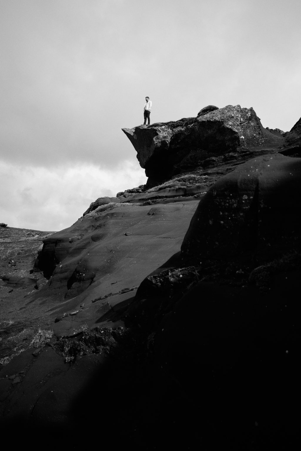 A lone figure on a rocky ridge above Krýsuvík, black and white