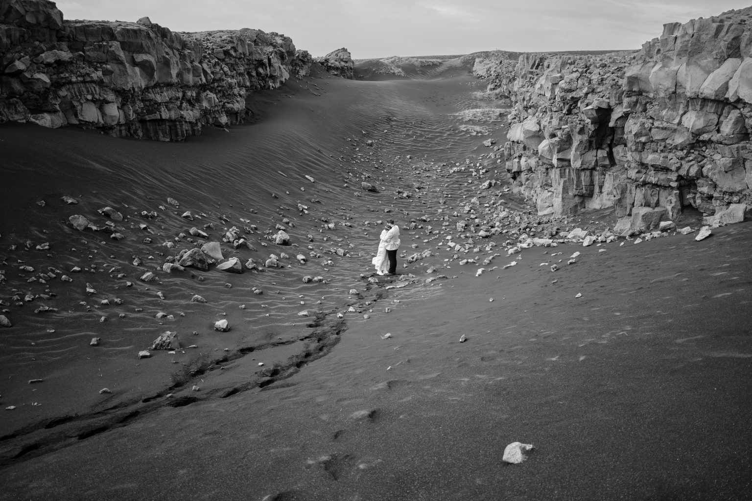 Bride small in a black sand canyon, Reykjanes elopement