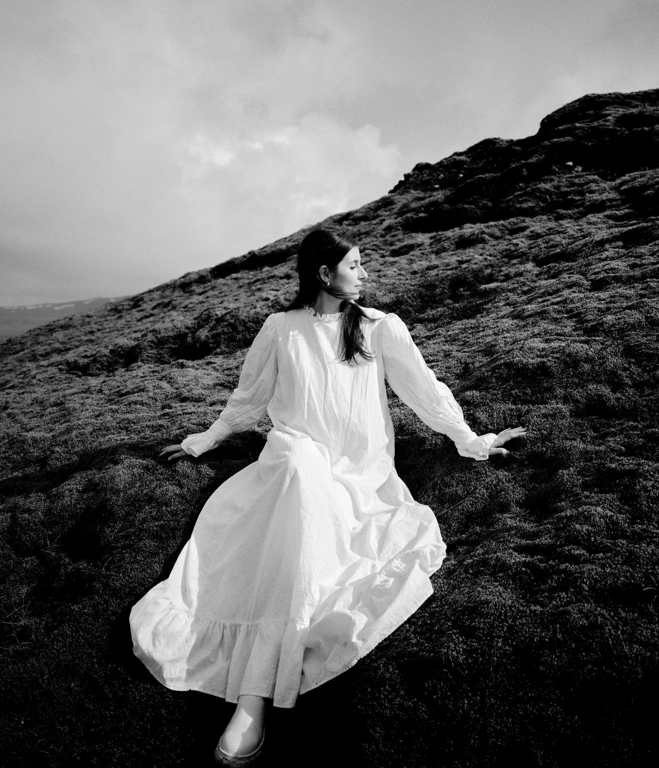 Bride in motion on a green slope at Krýsuvík, Reykjanes