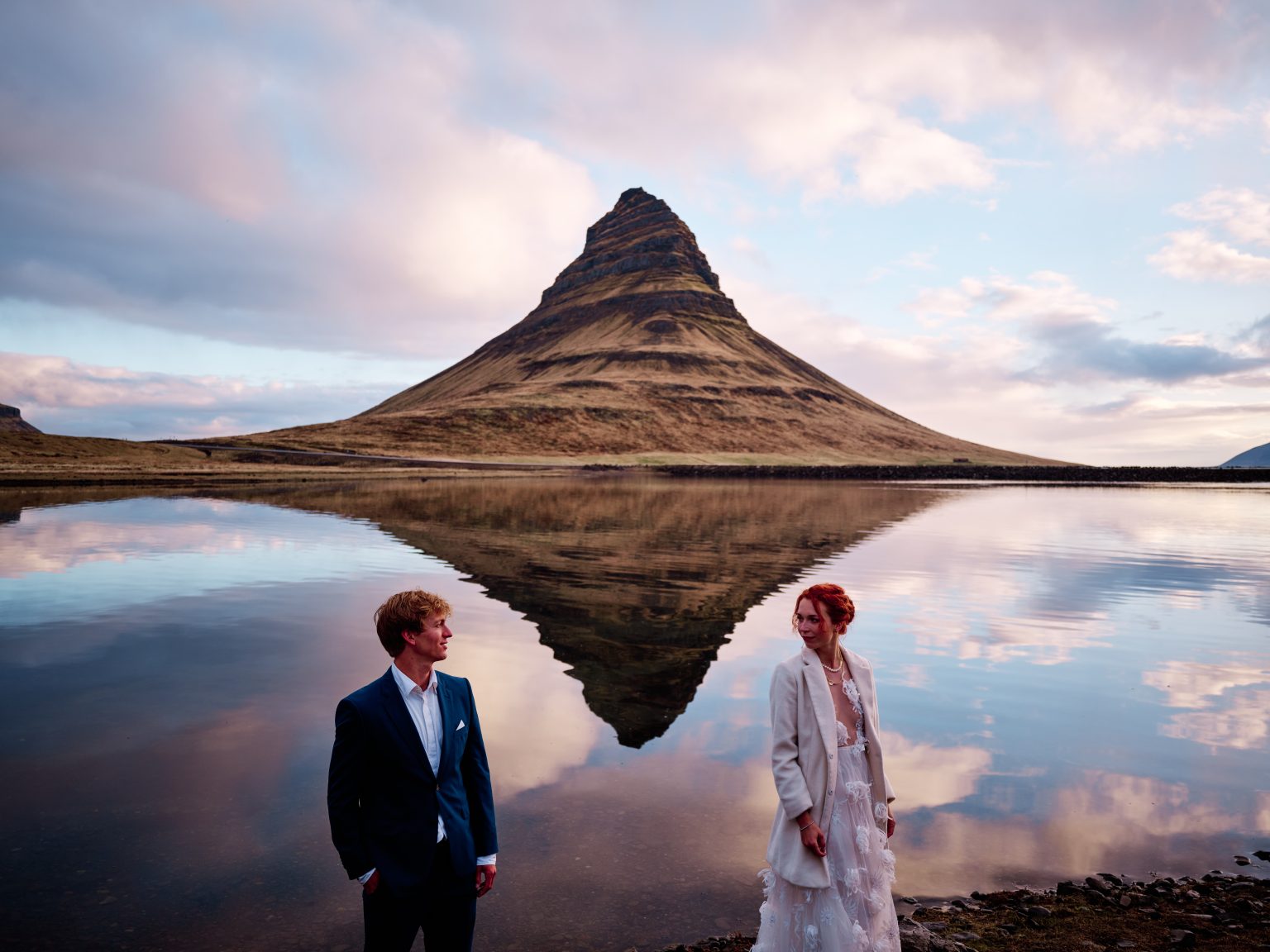 Kirkjufell mirrored in the water at sunrise on a Snæfellsnes elopement