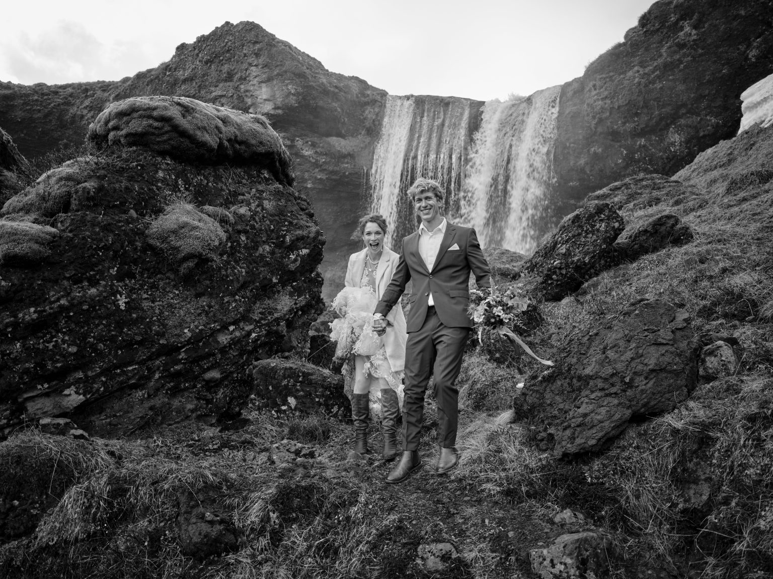Anna and Niklas at a waterfall in Iceland, black and white