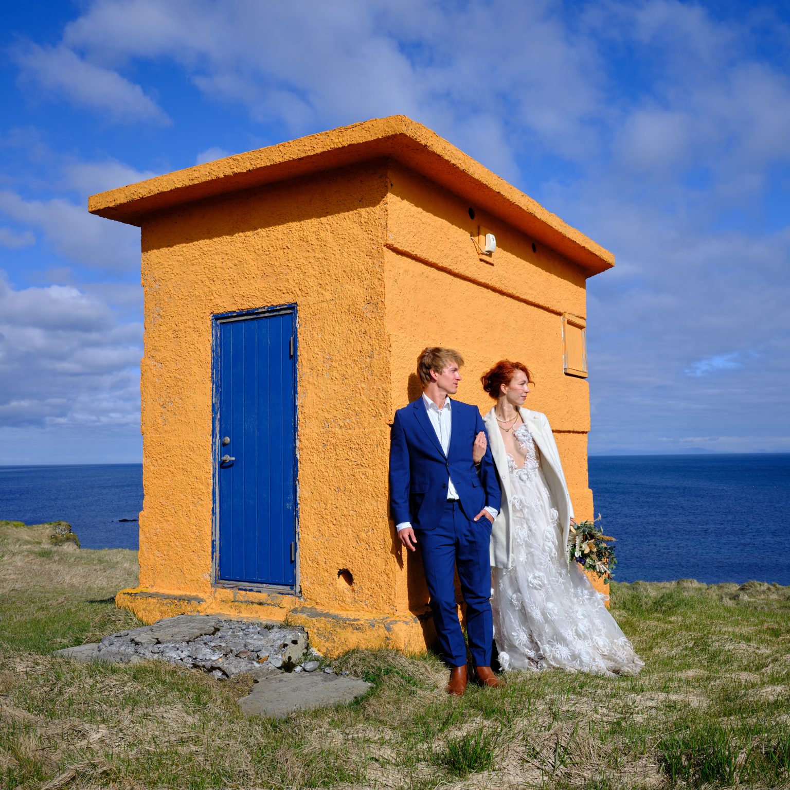 Anna and Niklas at the orange Svörtuloft lighthouse, Snæfellsnes