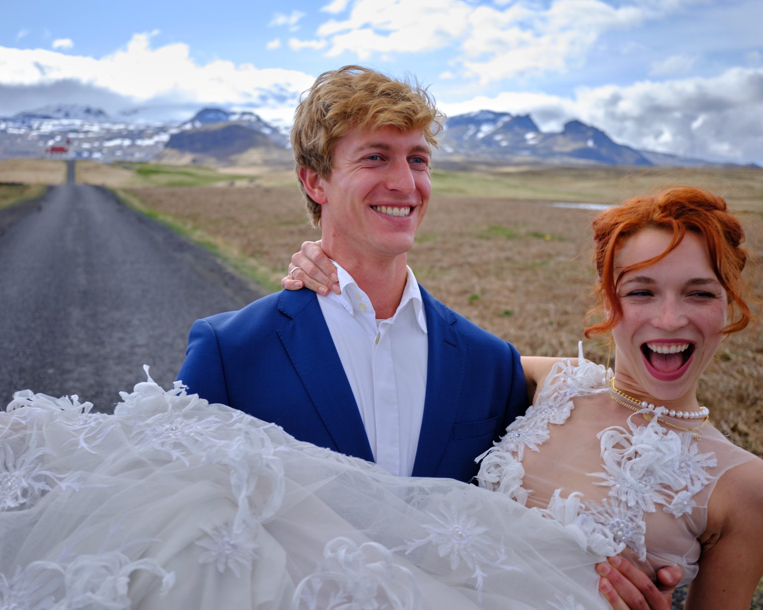 Couple laughing on a coastal road, Snæfellsnes