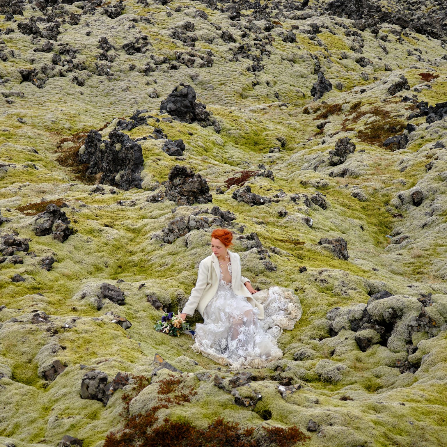 Bride walking through a moss-covered lava field, Snæfellsnes