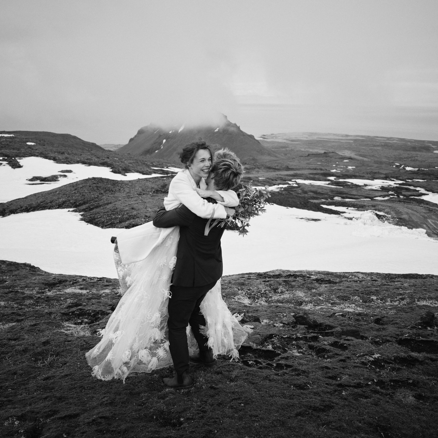 Anna and Niklas embracing in the snow up on Snæfellsjökull