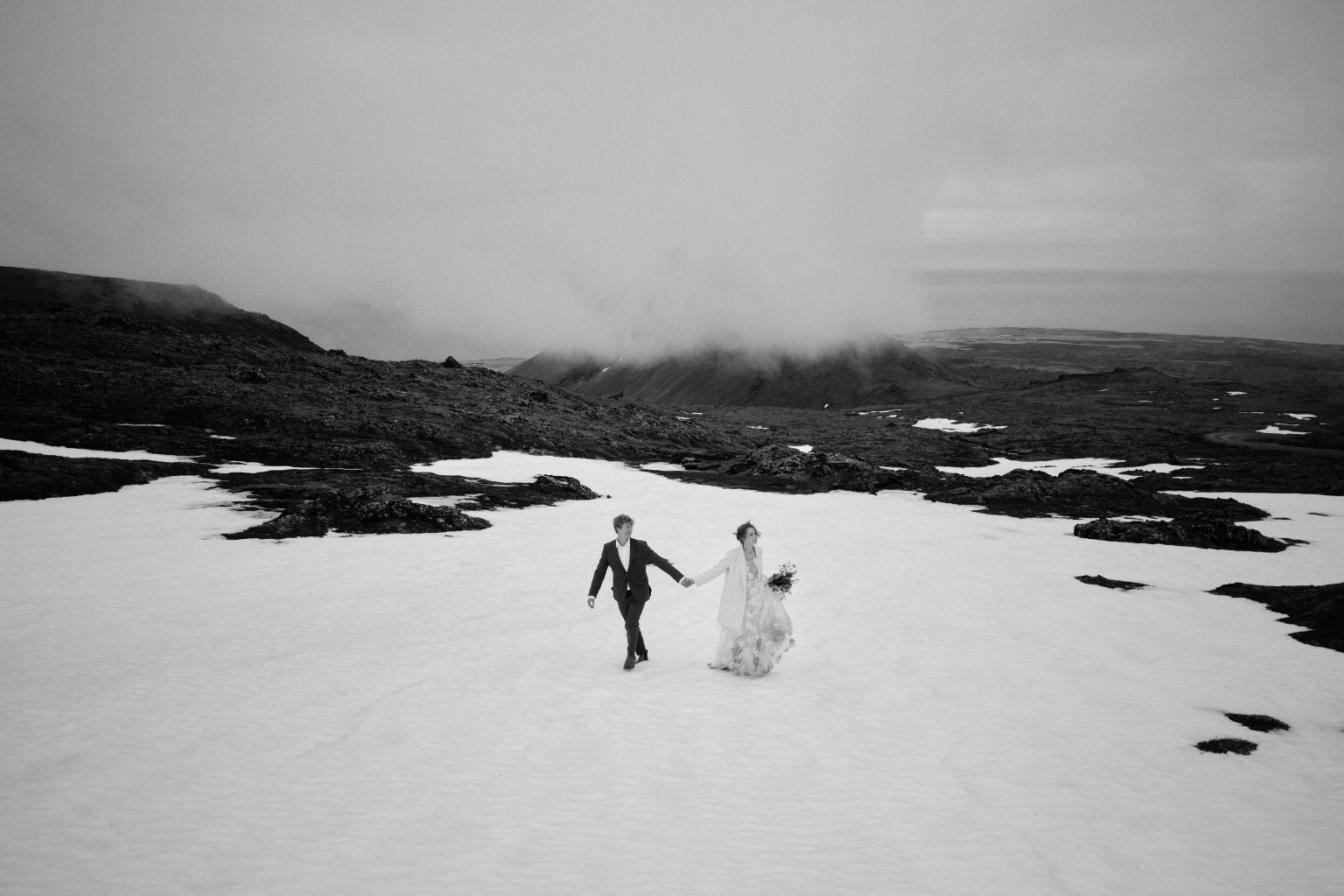 Tiny figures on the snowfield high on Snæfellsjökull in the cloud