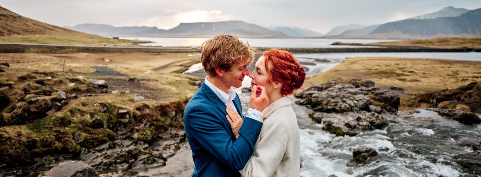 Anna and Niklas embracing by the water at Kirkjufell