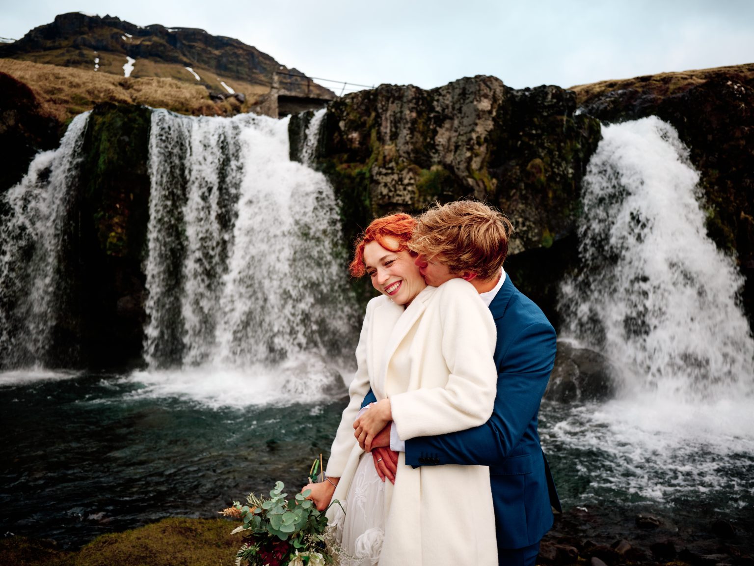 Elopement couple in front of Kirkjufellsfoss waterfall