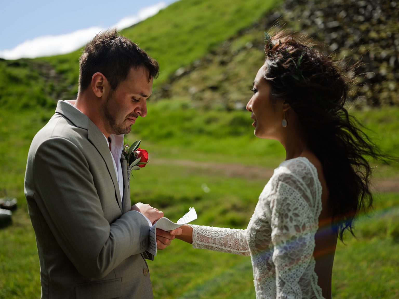 Couple reading their vows in the Kvernufoss canyon, South Iceland elopement ceremony