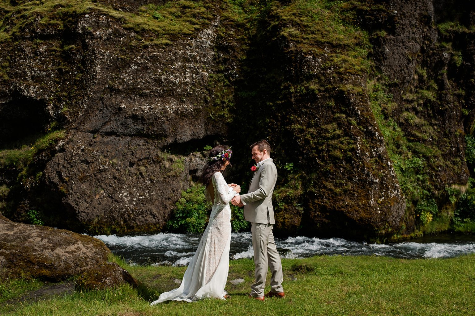 Couple in the Kvernufoss canyon beside the stream, South Iceland elopement